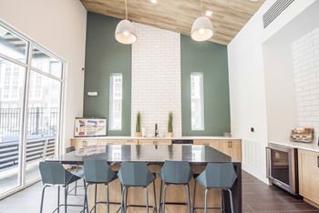 A kitchen with a table and chairs.